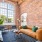 brick walled living room with large windows