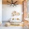 spacious naturally lit living room with ceiling fan